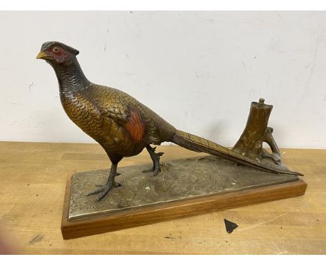 A mid 20thc novelty table lighter in the form of a cast metal painted Pheasant, the lighter found in stump with strike to sid