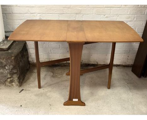 A Vintage mid century teak double drop leaf dining table, the shaped rectangular top on two gate legs and panel end supports 