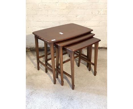 A vintage mid 20th century oak nest of three tables by Remploy, the rectangular tops raised on square splayed and shaped supp
