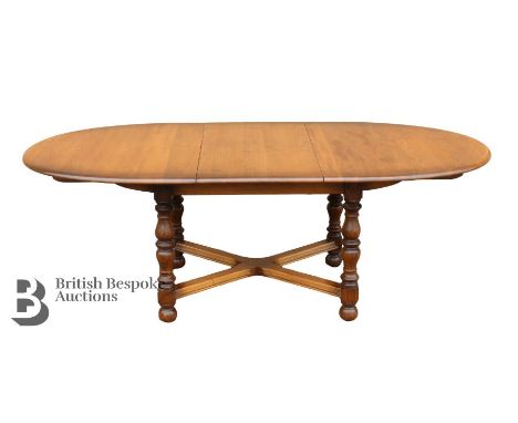 Ercol elm dining oval dining table, with x-frame stretchers on turned legs, complete with two carvers and four chairs. The ta