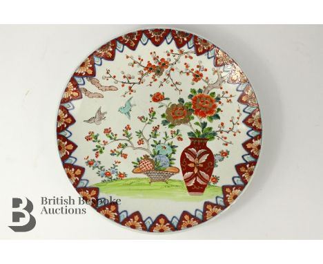 Japanese porcelain charger, 20th century, painted with a vase of peony, prunus blossom and fruit, approx 38 cms diameter.&nbs