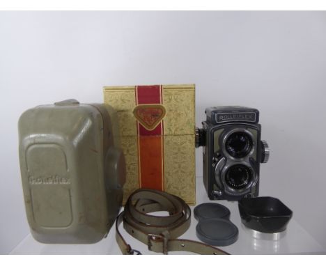 Rolleiflex 4 x 4 Camera, case, lens hood, strap and original box.