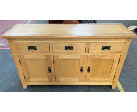 Contemporary light oak sideboard, consists of three drawers and three doors. 
