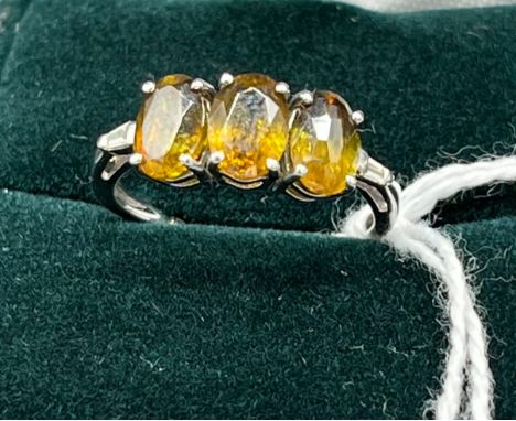 10ct white gold ladies ring set with three yellow/ amber coloured stones off set by diamond shoulders. [Ring size N] [2.50Gra