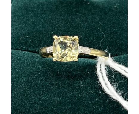 10ct yellow gold ladies ring set with pale green topaz off set by diamond shoulders. [Ring size P] [2.08Grams] 