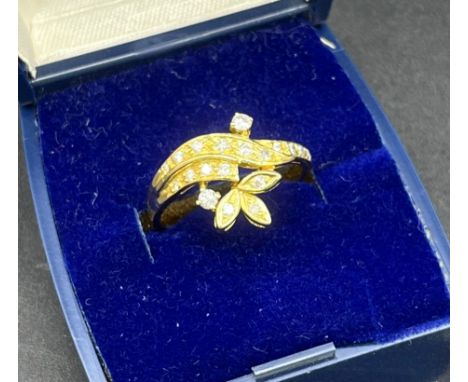 18t yellow gold and diamond ring. Set with 19 various sized diamonds. [Ring size P] [3.95grams] [Split in the band] 