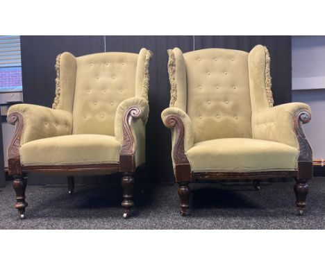 Pair of his and hers gullwing arm chairs with button back in sage green colour 