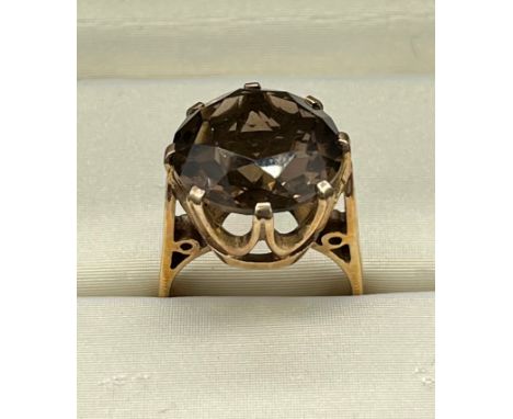 A 9ct yellow gold and large smokey quartz stone ring. [Ring size M] [7.42Grams] 