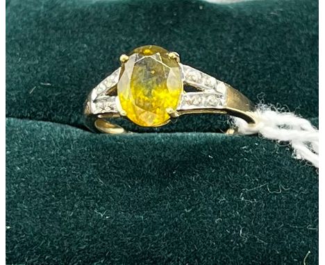 10ct yellow gold ladies ring set with a yellow stone off set by diamond shoulders. [Ring size N] [2.23Grams] 
