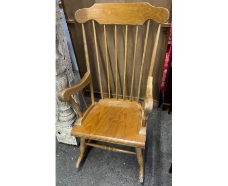Light wood rocking chair with arm rests. 