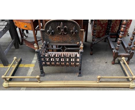 Antique Cast iron fire grate together with a brass fire fender. 