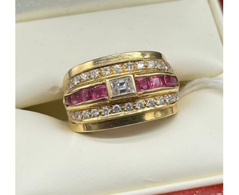 High grade gold [18ct-24ct- tested] ladies diamond and ruby stone ring. Baguette cut diamond centre off set by baguette cut r