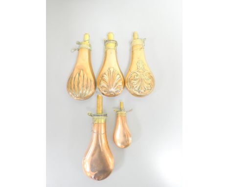 Five antique copper powder flasks to include embossed examples to include a 5'' miniature flask. (5)
