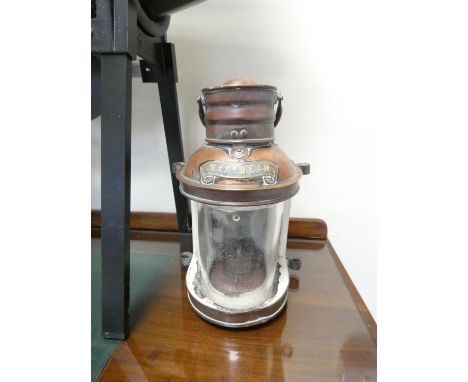 A glazed copper ship's oil lamp stamped Masthead. Height 28cm.