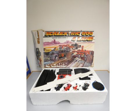 Scalextric 600 4-lane boxed racing set with track, vehicles and controllers.
