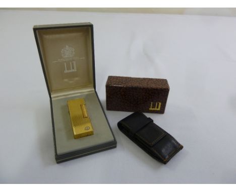 Dunhill gold plated cigarette lighter in original packaging and a Dunhill leather case with original packaging