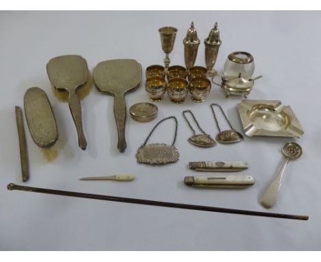 A quantity of silver and white metal to include condiments, a dressing table set, wine labels and swagger stick with silver h