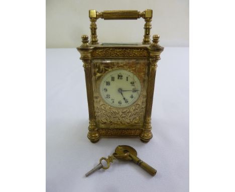 A brass carriage clock of customary form enamel dial, Arabic numerals, to include key, A/F