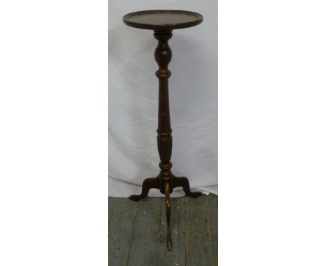 A mahogany plant stand on tripod base with outswept legs