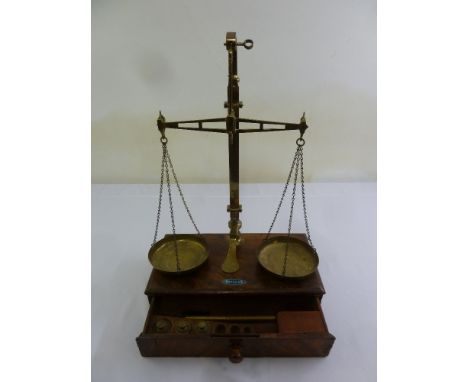 A Victorian mahogany and brass balance scale with rectangular base and single drawer to include weights