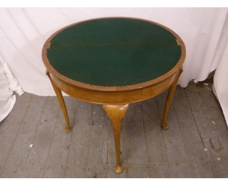 A mahogany demilune card table on four cabriole legs