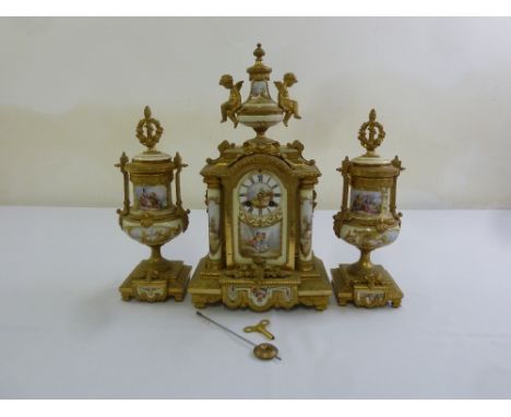 A 19th century French ormolu mantle clock, with Sevres porcelain panels to the clock and matching garniture, two train moveme