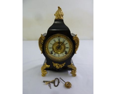 A black slate with gilded mounts mantle clock,  enamel dial, Roman numerals, two train movement to include key and pendulum