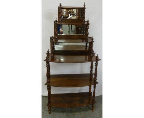 A Victorian mahogany six shelf shaped rectangular whatnot with baluster turned columns and mirror backed shelves