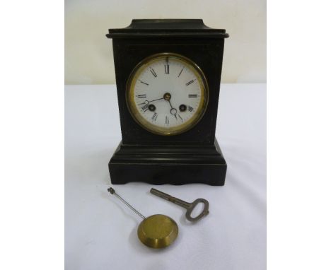 A black slate mantle clock enamel dial, Roman numerals, two train movement to include key and pendulum