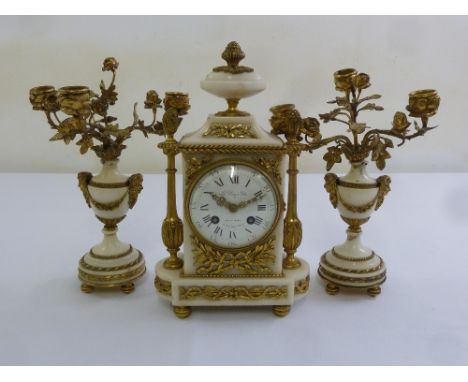 A French Le Roy 19th century ormolu and white marble mantle clock, flanked by vase form garnitures surmounted by flowers and 