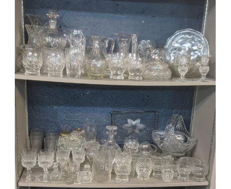 A large quantity of mainly crystal cut glassware comprising of a variety of vases, fruit bowls, decanters, a pair of candlest