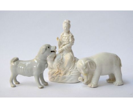 Three ceramic figurines of a dog, an elephant and Chinese goddess of mercy sitting on a Foo dog