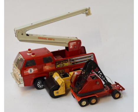 A vintage Tonka fire engine crane together with two others