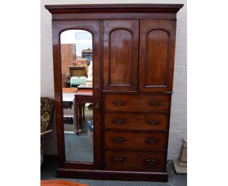 A Victorian mahogany combination wardrobe with drawers below and mirror to the side
