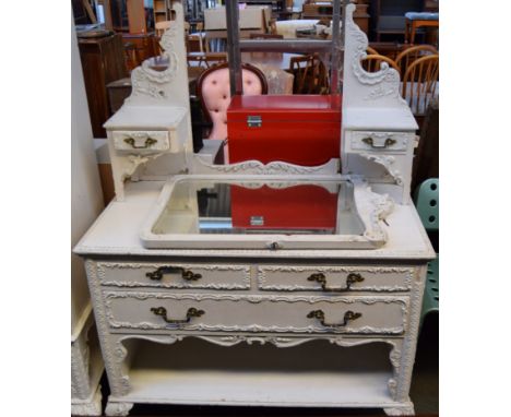 A white painted dressing table with mirror and two short drawers over one long, with foliate detailing