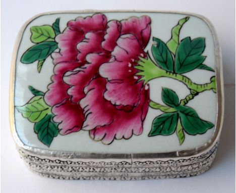 A poss Indian lidded trinket box with a floral decoration. Made in silver, unmarked