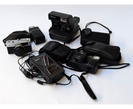 A quantity of cameras including an Olympus Trip 35, a Polaroid 636 Closeup, an Agfamatic 1008, three other 35mm cameras, and 