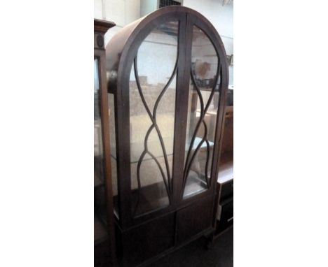 A glass fronted display cabinet with curved top, one shelf and two cupboard doors beneath 72 x 103cmH