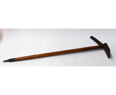 A vintage mountaineering pickaxe engraved 'H.V.B' and bearing a makers mark in Zermatt, complete with leather sheaths 87cmL