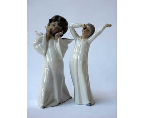 Two Lladro figurines, one of a girl stretching and yawning, marked NAO, once of angel in white robes