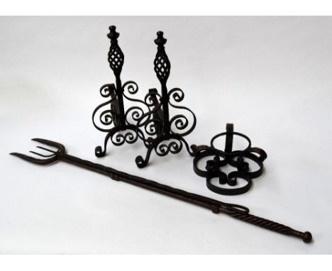 A mixed lot of wrought iron to include - two wall mounted brackets, a toasting fork, a larger fork and a wrought iron stand (