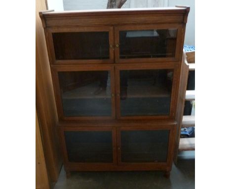 A three part glazed bookshelf with two doors per shelf 29 x 132cmH x 90cm