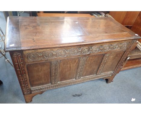 AN OAK COFFER, WITH CARVED RAILS on later bracket feet (some detached) 120cm wide