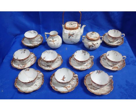 A JAPANESE SATSUMA EGGSHELL TEA SERVICE painted with exotic bird subjects, late 19th century