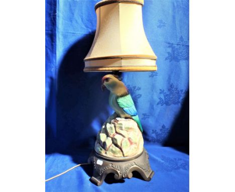 A CERAMIC PARROT TABLE LAMP on a brass base 37cm high plus fitting