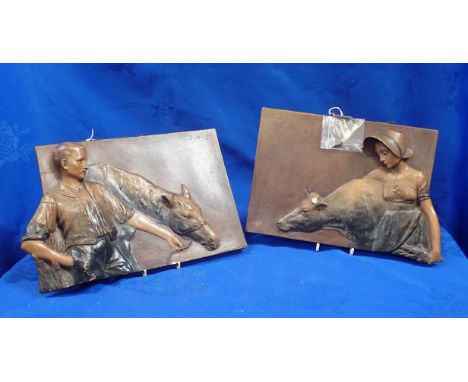 A PAIR OF EARLY 20th CENTURY AUSTRIAN CERAMIC PLAQUES depicting a farmer and his wife 32 x 22cm (some damage)