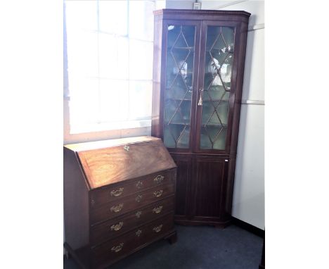 A GEORGE III MAHOGANY BUREAU late 18th Century, the green tooled leather lined fall front enclosing fitted interior, four lon