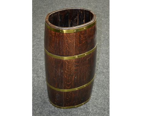 An oak coopered brass bound oval barrel stick stand.