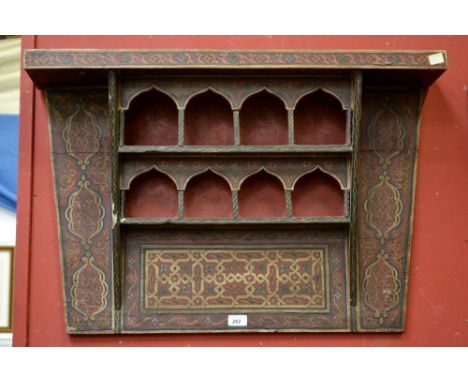 A North African wall shelf in the Moorish taste, arched alcoves and geometric designs throughout.