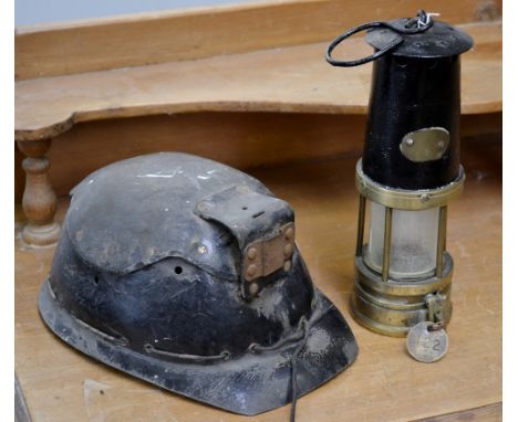 A miner's lamp with tally/check, Fuller Lamp/122; a miner's helmet